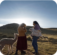 Imagen de dos mujeres mirando al horizonte desde un monte